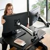 Woman adjusting Dual-Monitor Arm stand