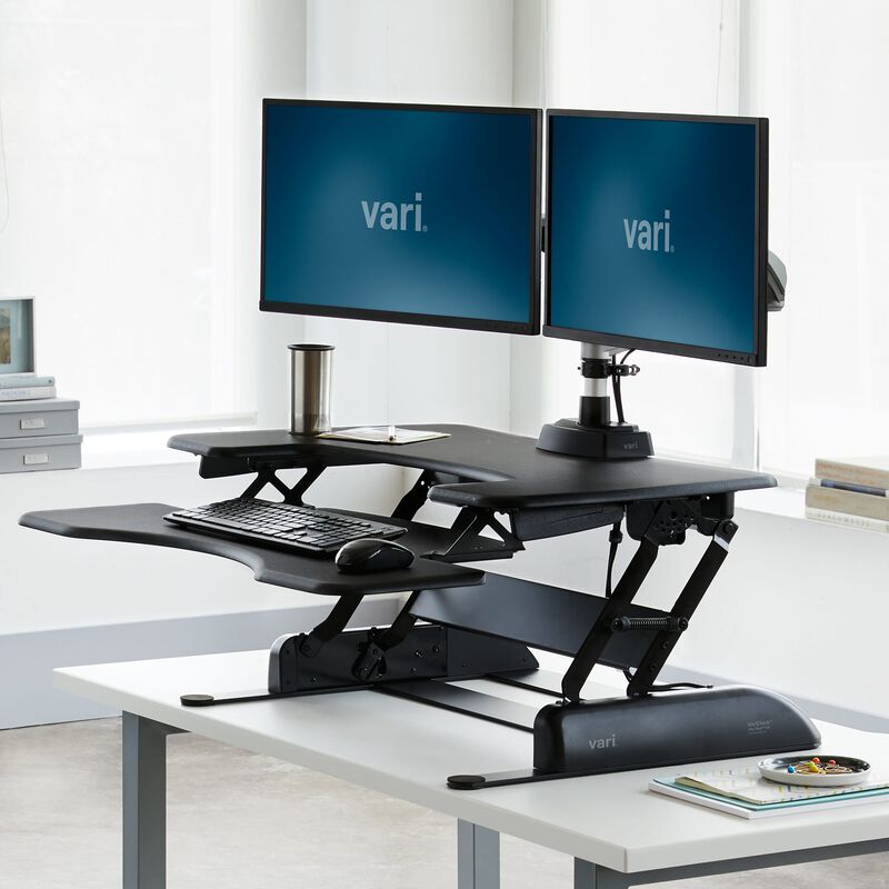 varidesk pro plus 36 black sit-stand desk converter in raised position in office image number null